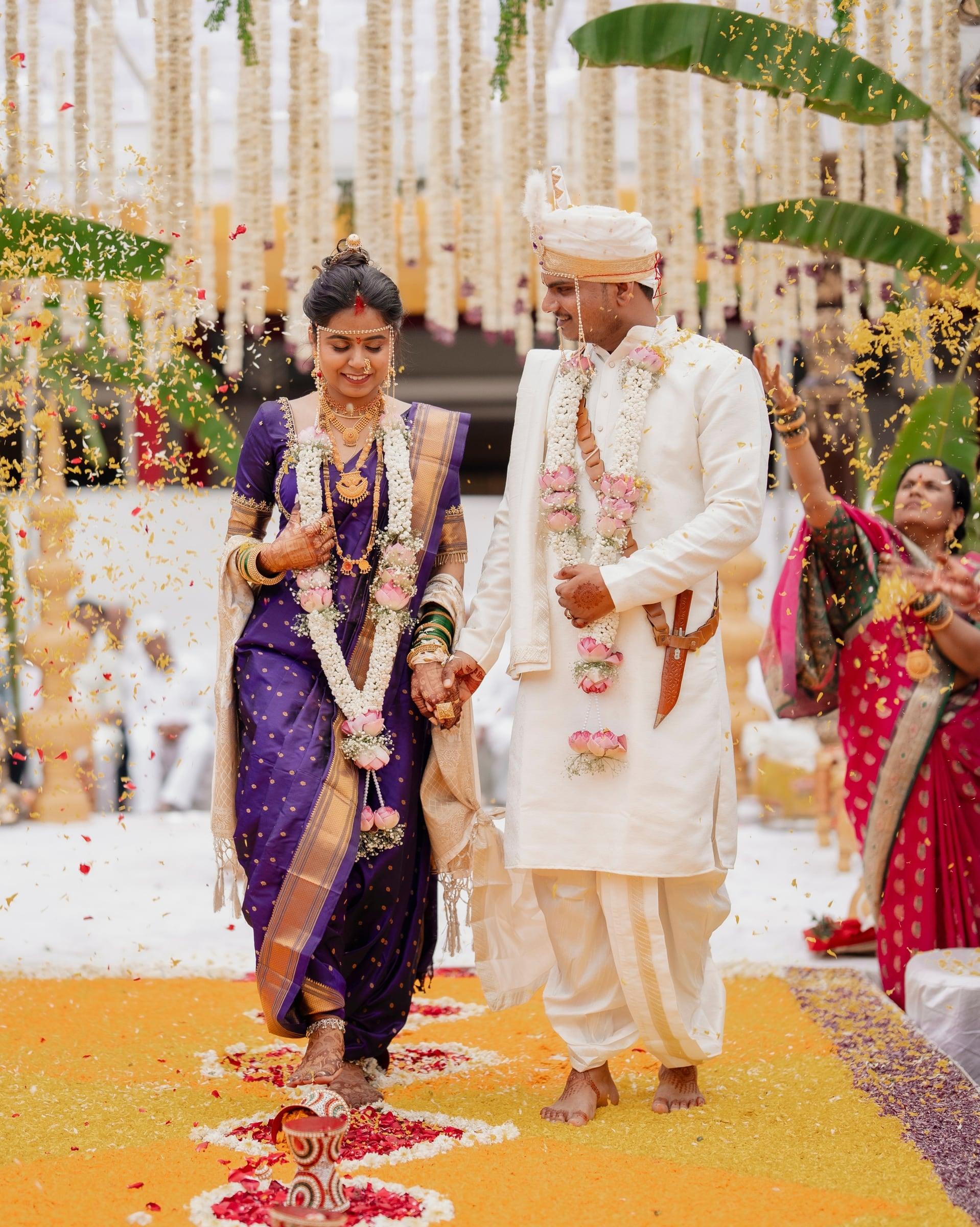 Shivani and Pankaj walking through a shower of petals at their Nashik wedding