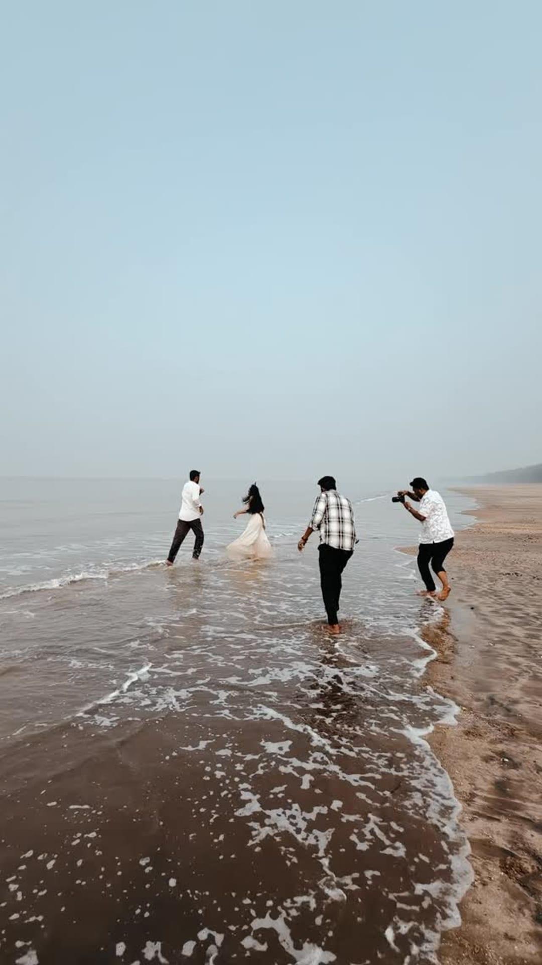 Behind the scenes: the Art of Rohit team photographing a couple in the waves